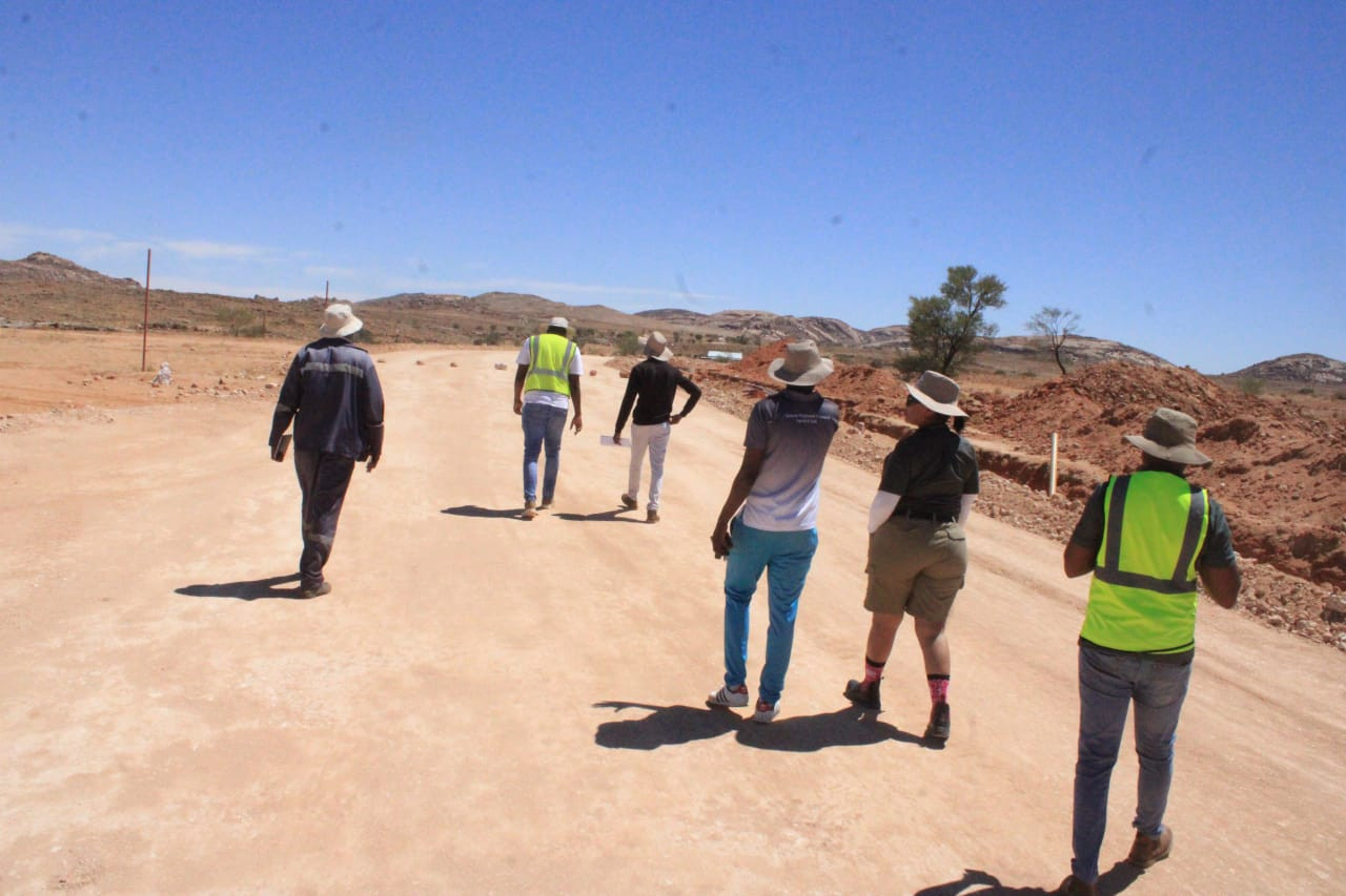 IDEAL engineers walking a road formation at Aus